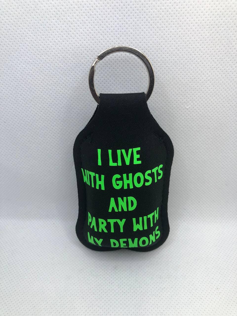 Black Glow In The Dark Skeleton Hand with "I live with ghosts and party with my demons" Hand Sanitizer Keychain/Lotion Keychain/Sunscreen
