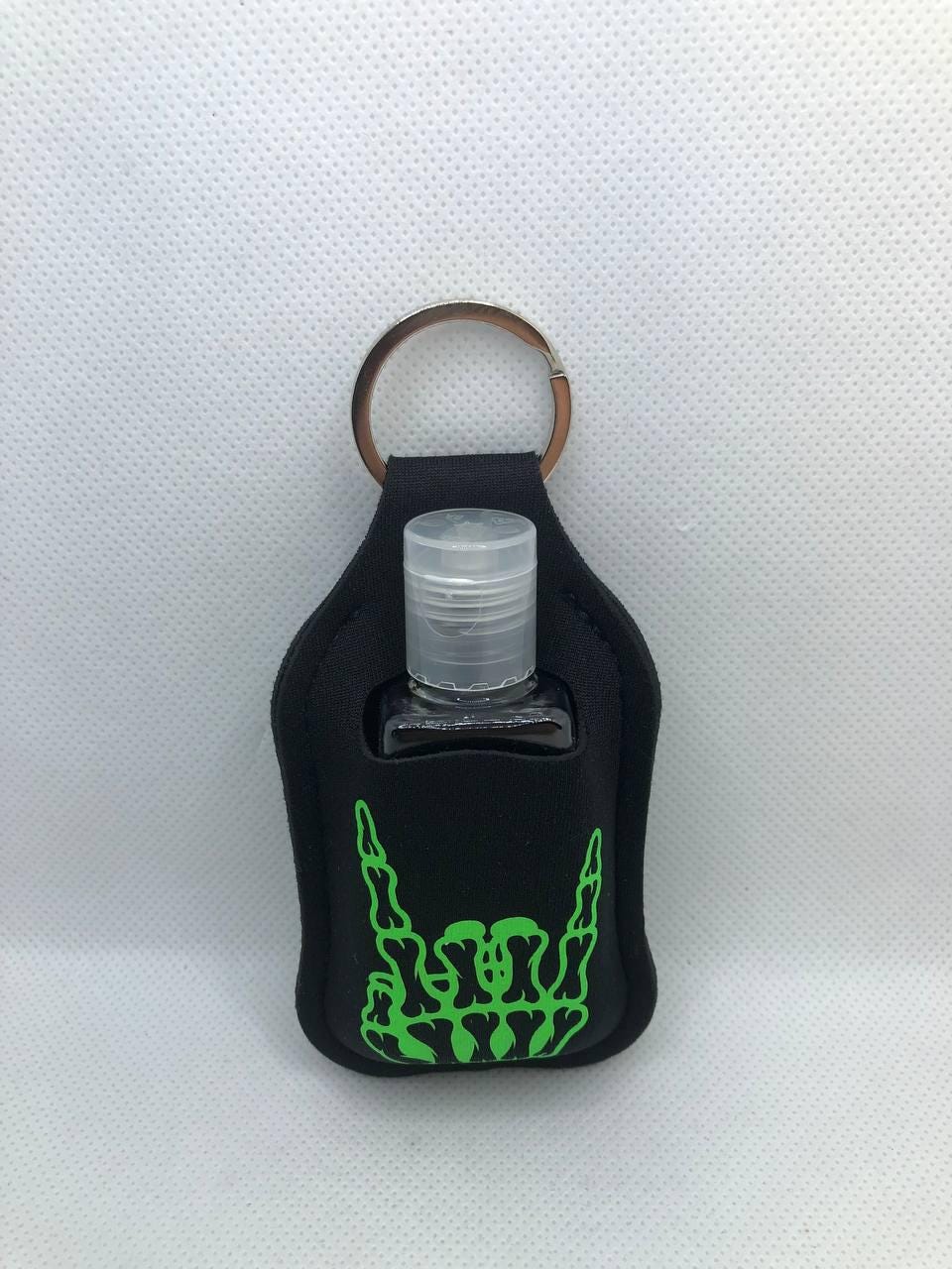Black Glow In The Dark Skeleton Hand with "I live with ghosts and party with my demons" Hand Sanitizer Keychain/Lotion Keychain/Sunscreen
