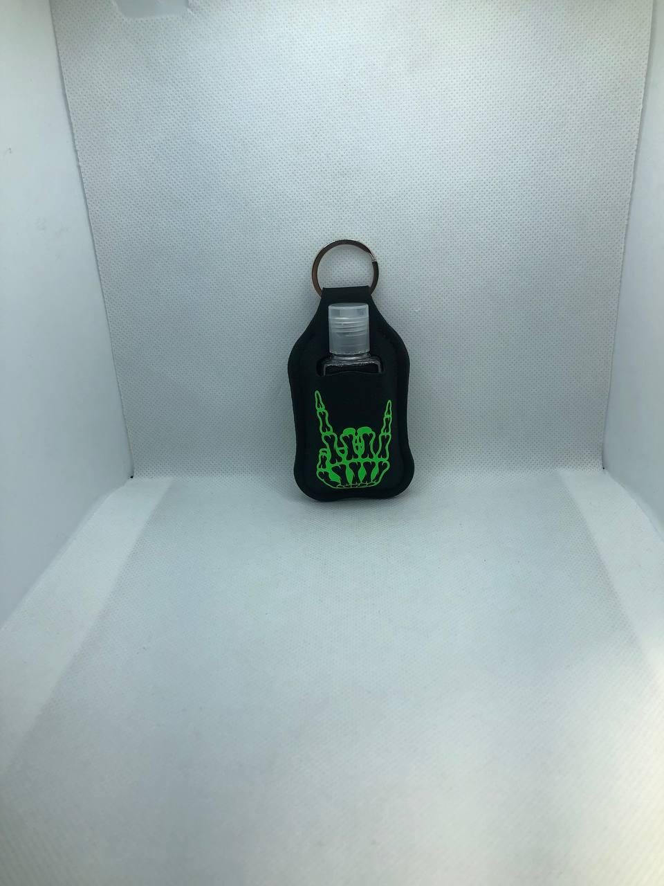 Black Glow In The Dark Skeleton Hand with "I live with ghosts and party with my demons" Hand Sanitizer Keychain/Lotion Keychain/Sunscreen